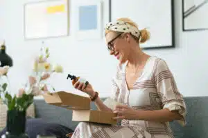 Personalized skincare; Woman opening a package with skincare products
