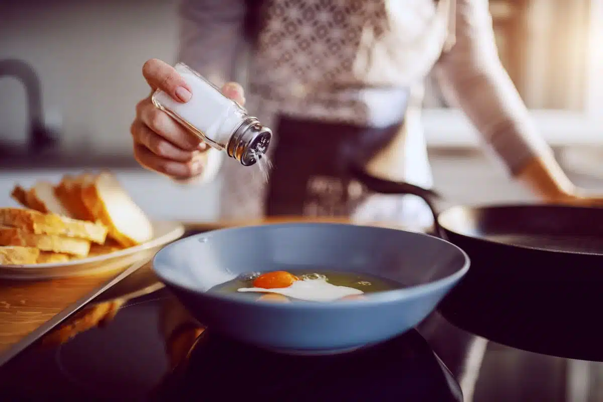 Adding salt to a bowl of soup
