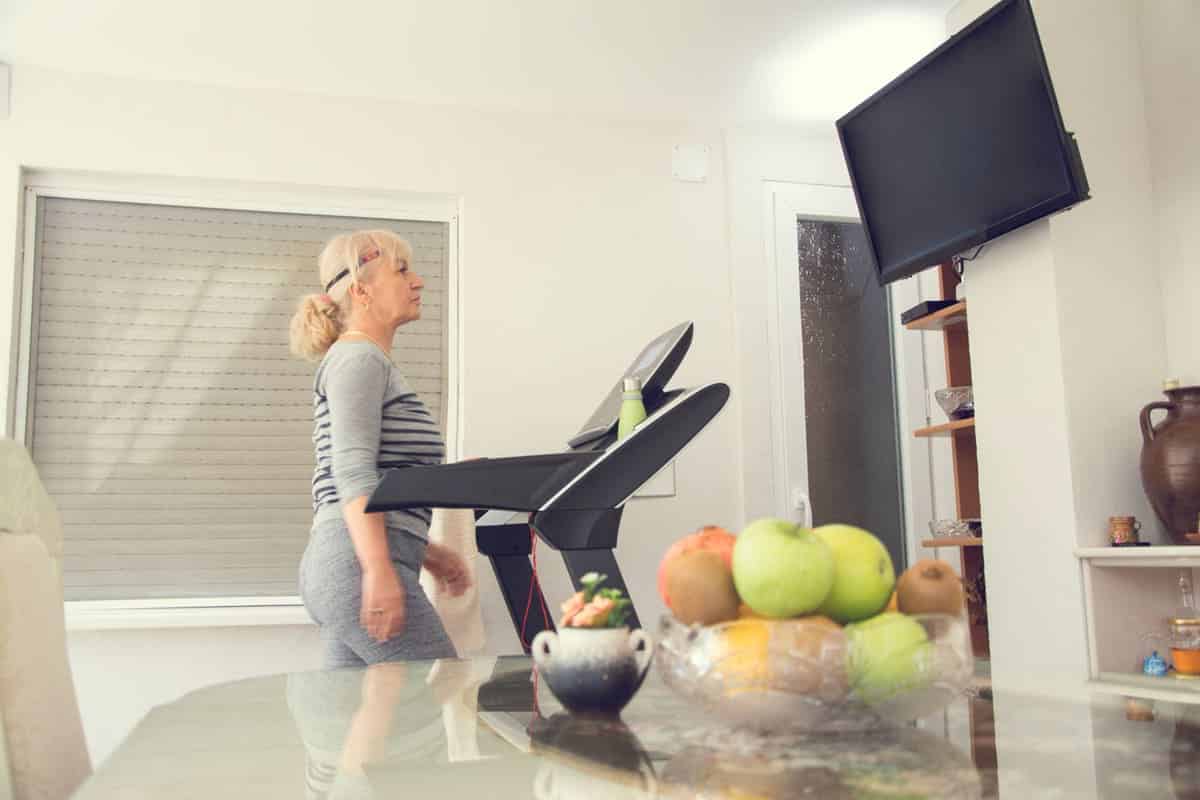 Woman on a treadmill watching TV