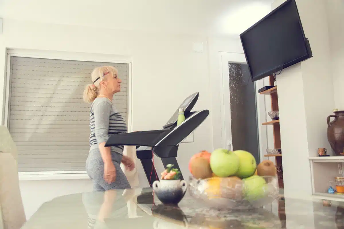 Woman on a treadmill watching TV