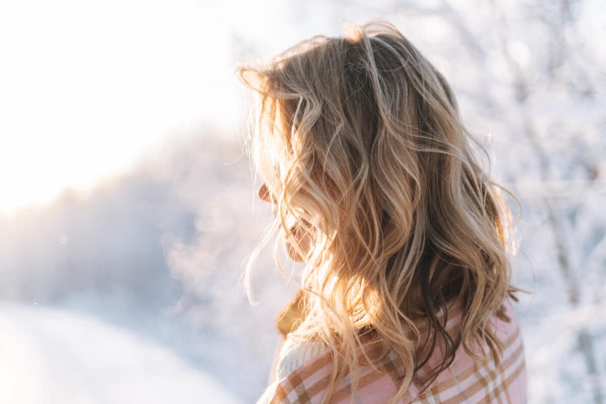 blonde woman, wavy hair, winter hair care tips