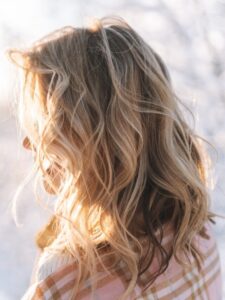 blonde woman, wavy hair, winter hair care tips