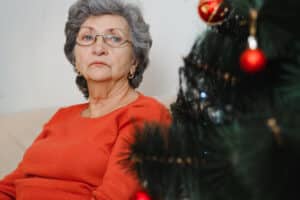 Sad woman at Christmas time; how to help a friend who is grieving