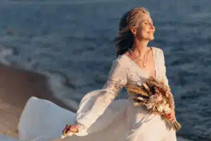 Happy senior woman in wedding dress.