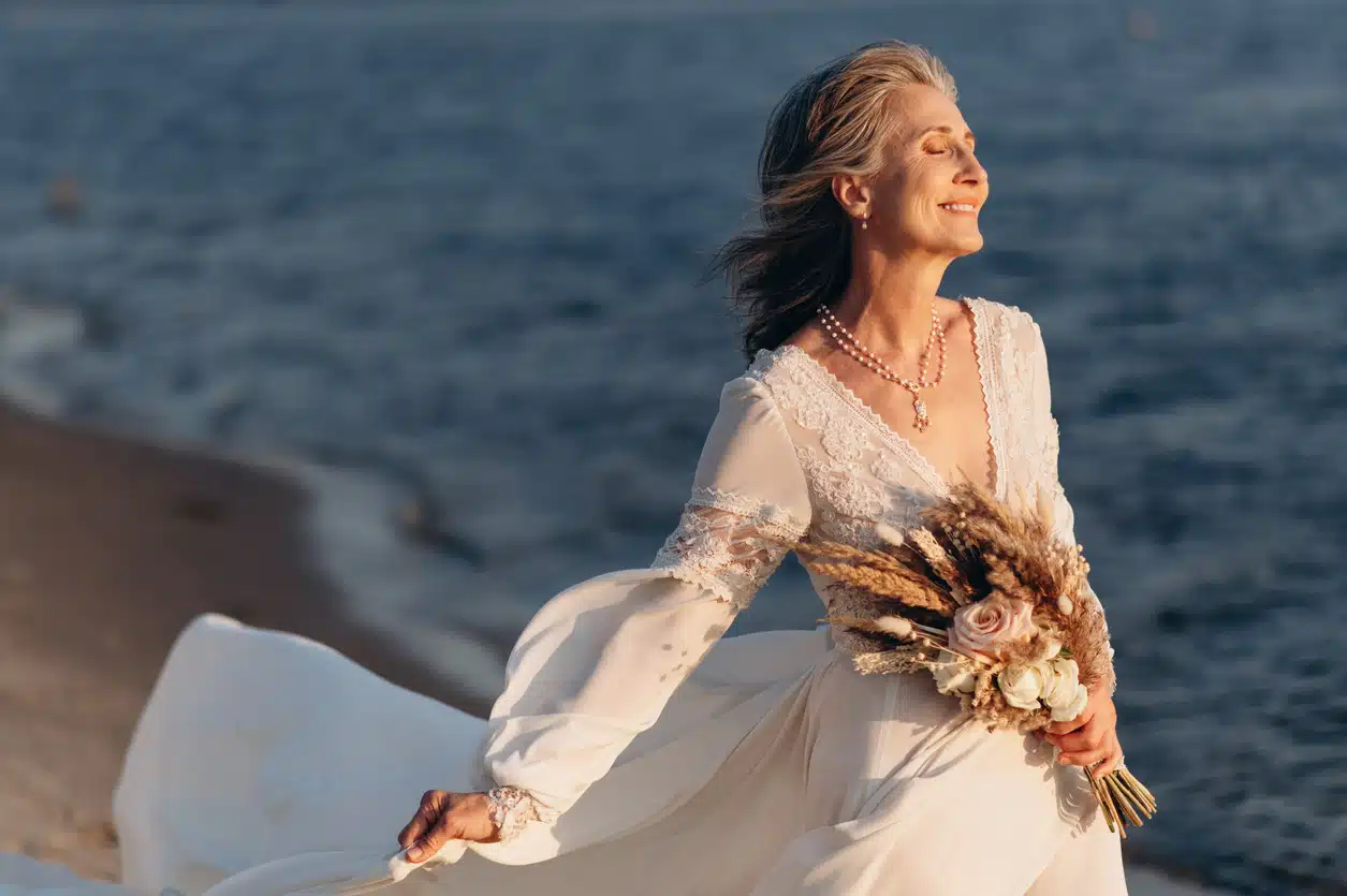 Happy senior woman in wedding dress.