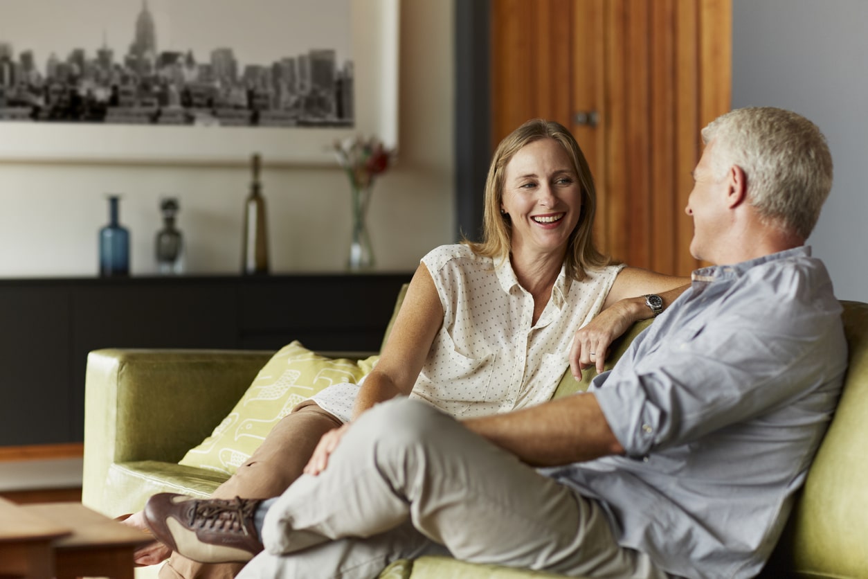Happy mature couple spending leisure time in living room