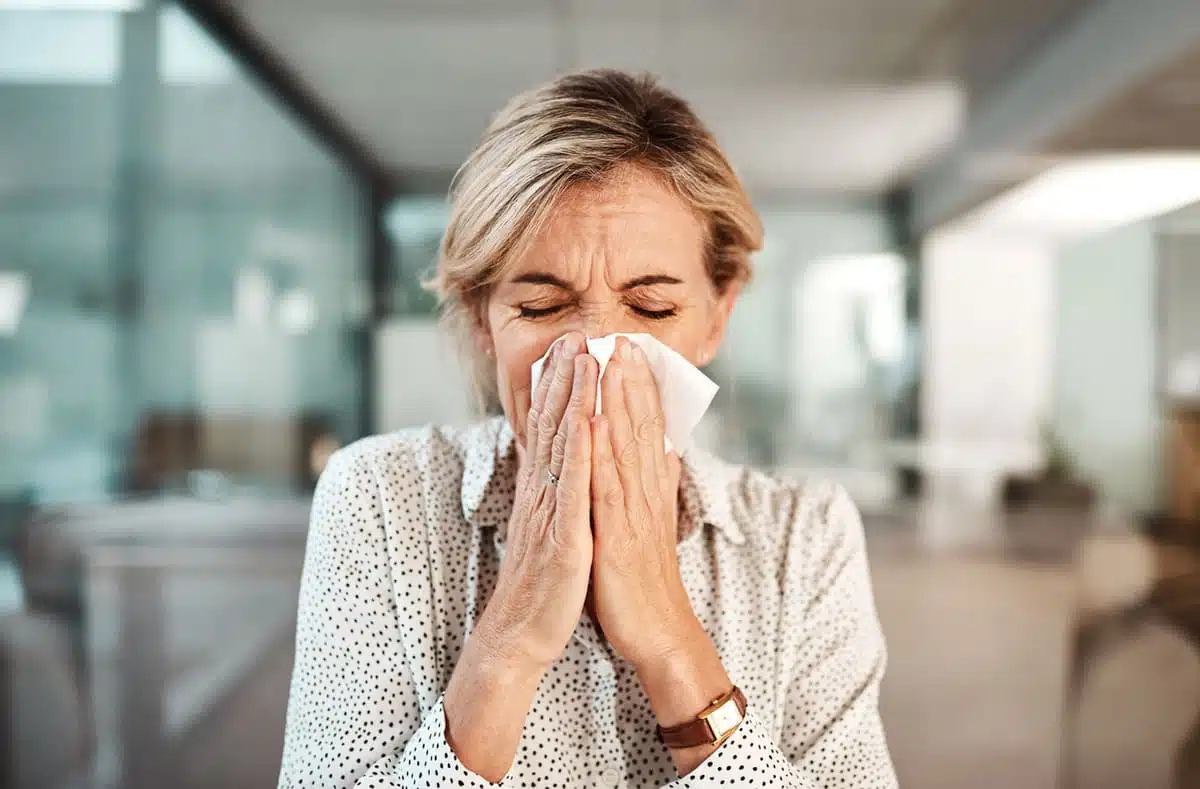 woman blowing her nose
