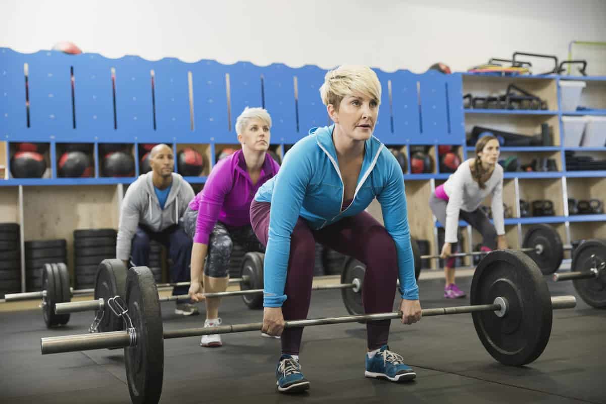 woman doing a deadlift in exercise class