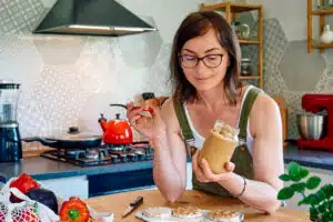 Woman eating peanut butter; Nut Butters FEATURE