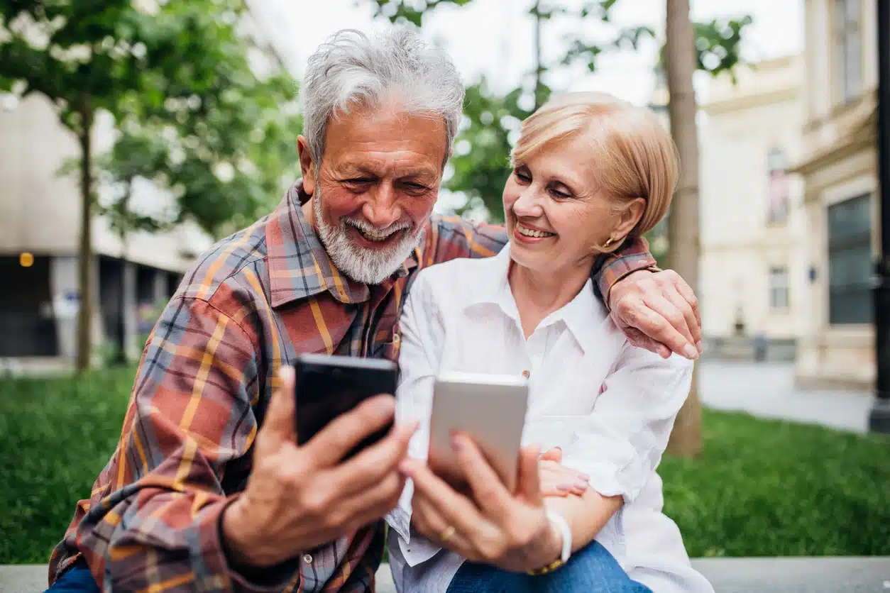 Senior couple using smartphones
