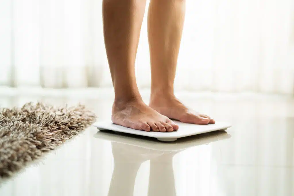 woman standing on digital weight scale