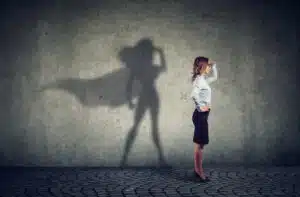 Side view of a business woman imagining to be a super hero looking aspired.