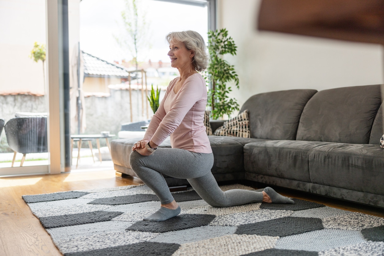 Woman doing lunges in her living room