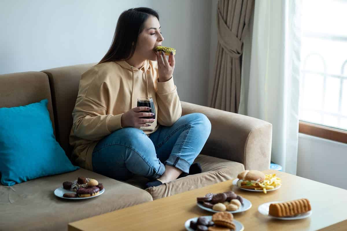 woman eating donuts and junk food