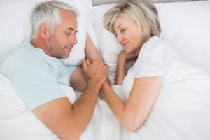 Couple lying in bed together