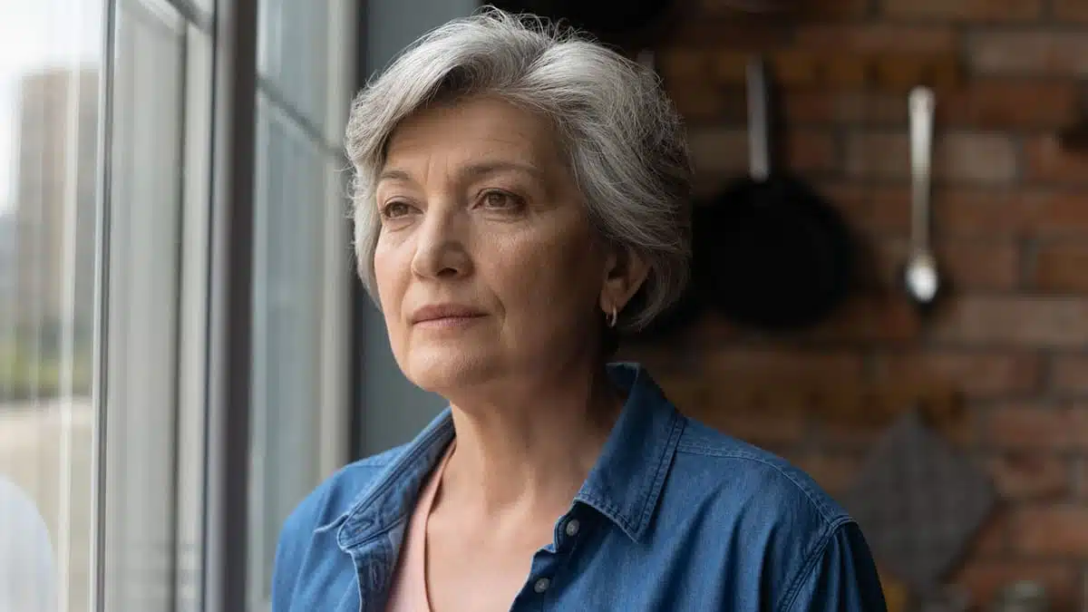 Sad or pensive woman looking out the window