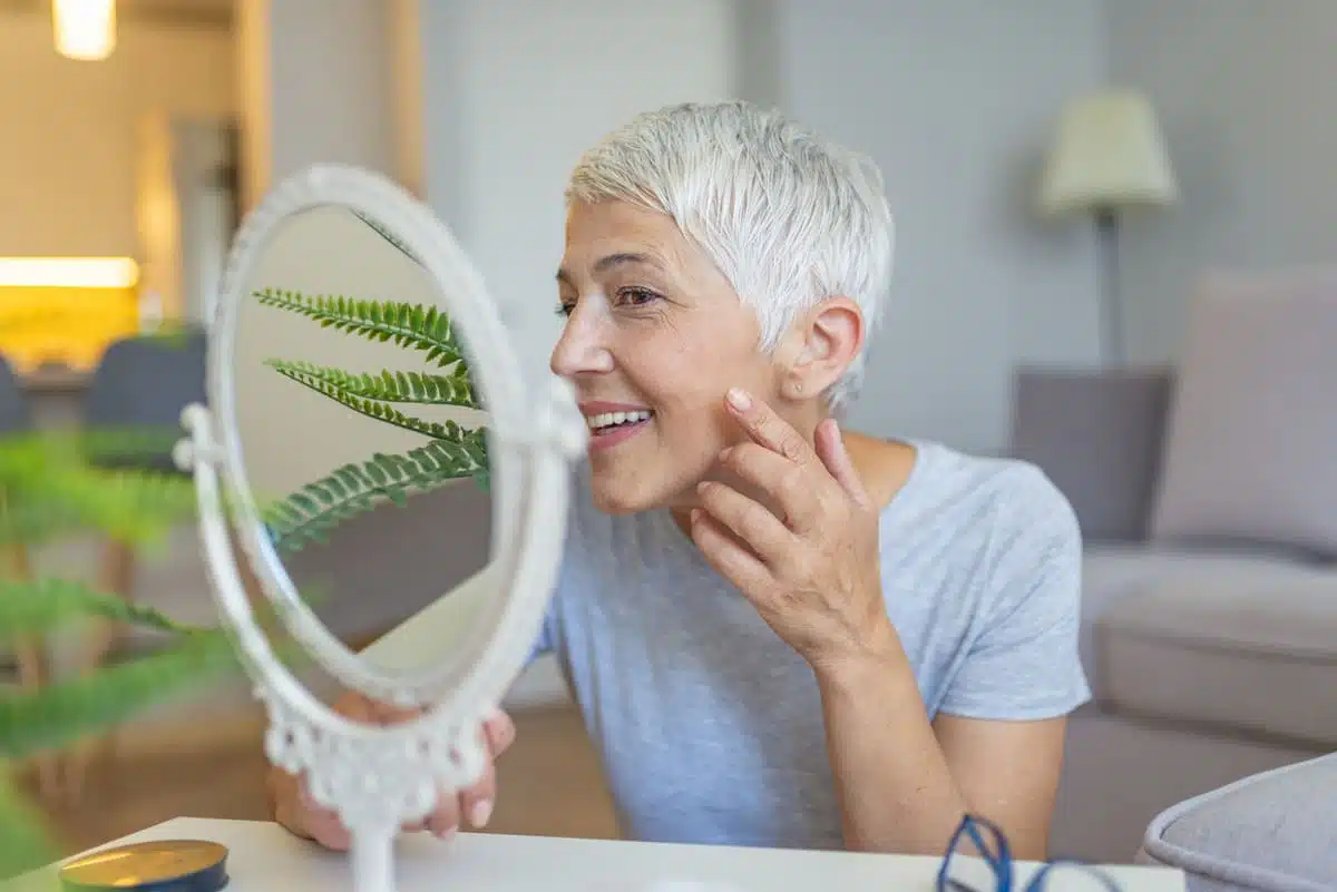 Skincare woman looking in the mirror