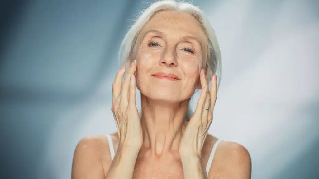 Woman applying a face mask or face cream
