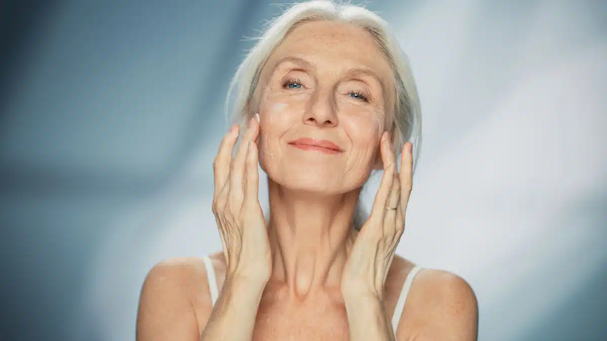 Woman applying a face mask or face cream