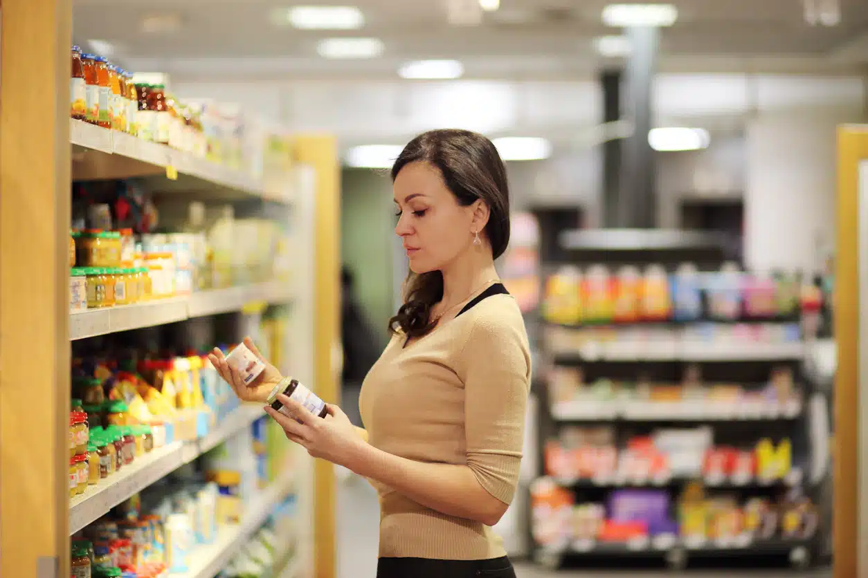 Woman checking food labels when shopping