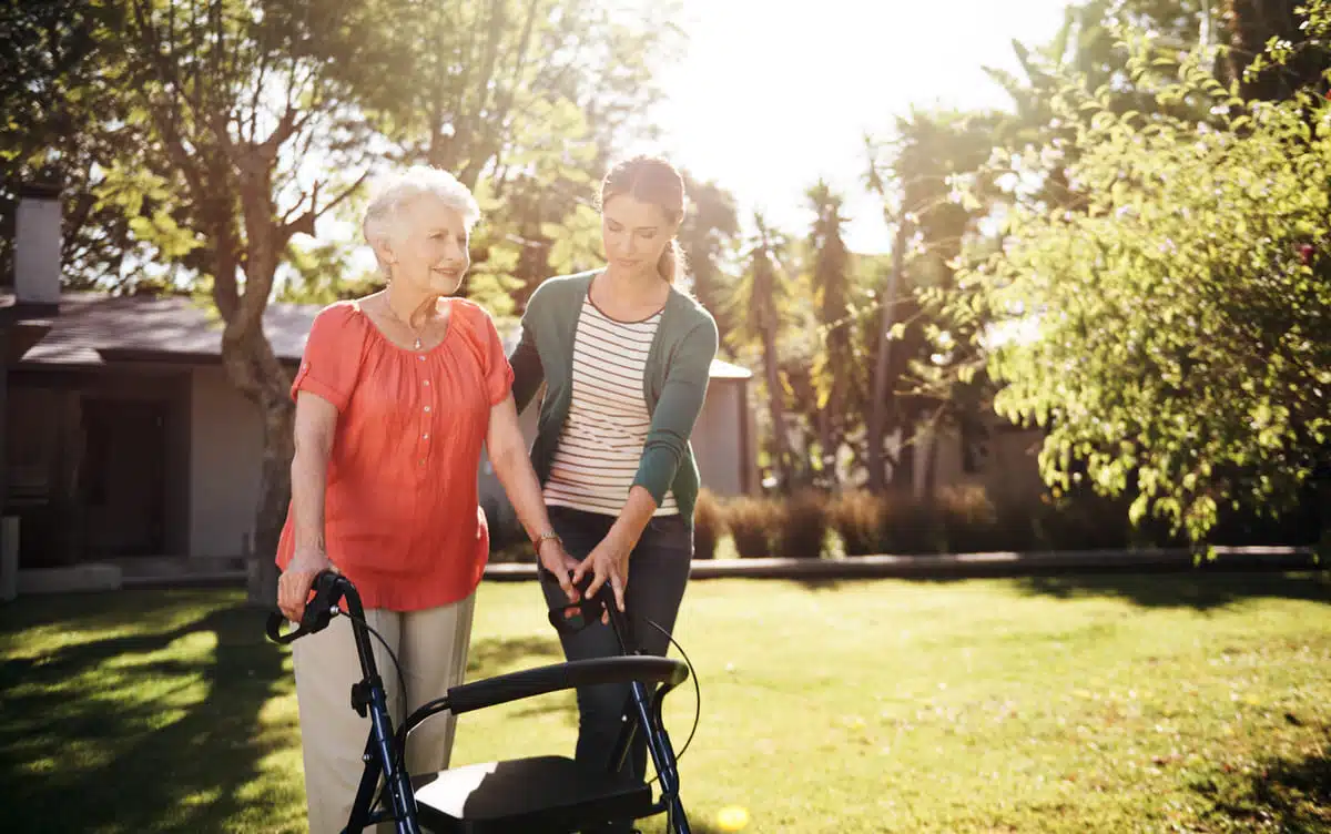 Woman with a walker with a nurse or her daughter