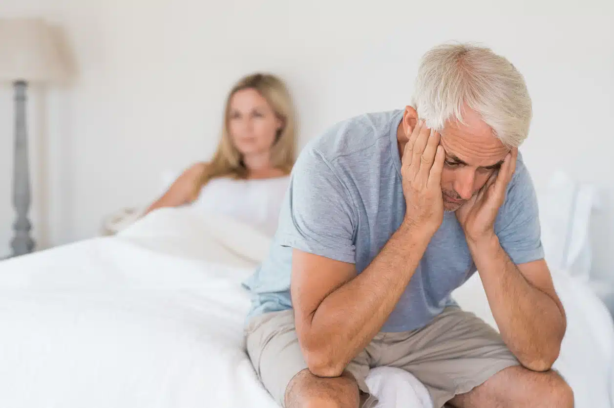 Upset mature couple ignoring each other. Close up of a worried senior man in tension at bed. Senior couple angry with each other after a fight.