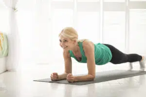 woman doing planks, no-equipment exercise at home