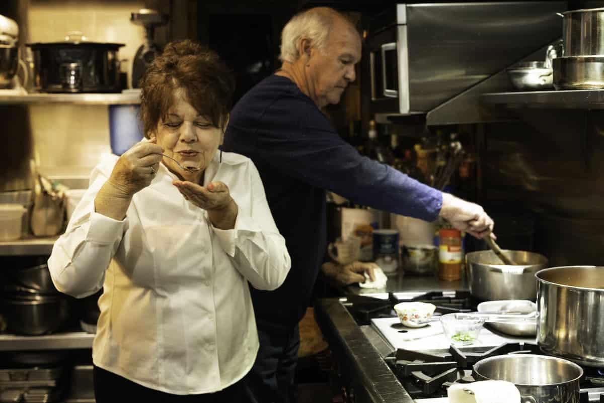 Woman tasting gumbo in the kitchen for Mardi Gras