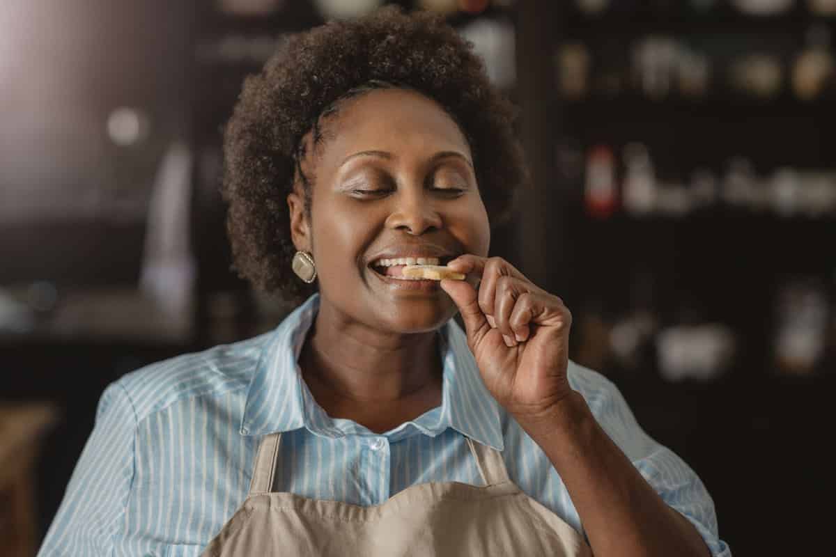woman biting into a cookie