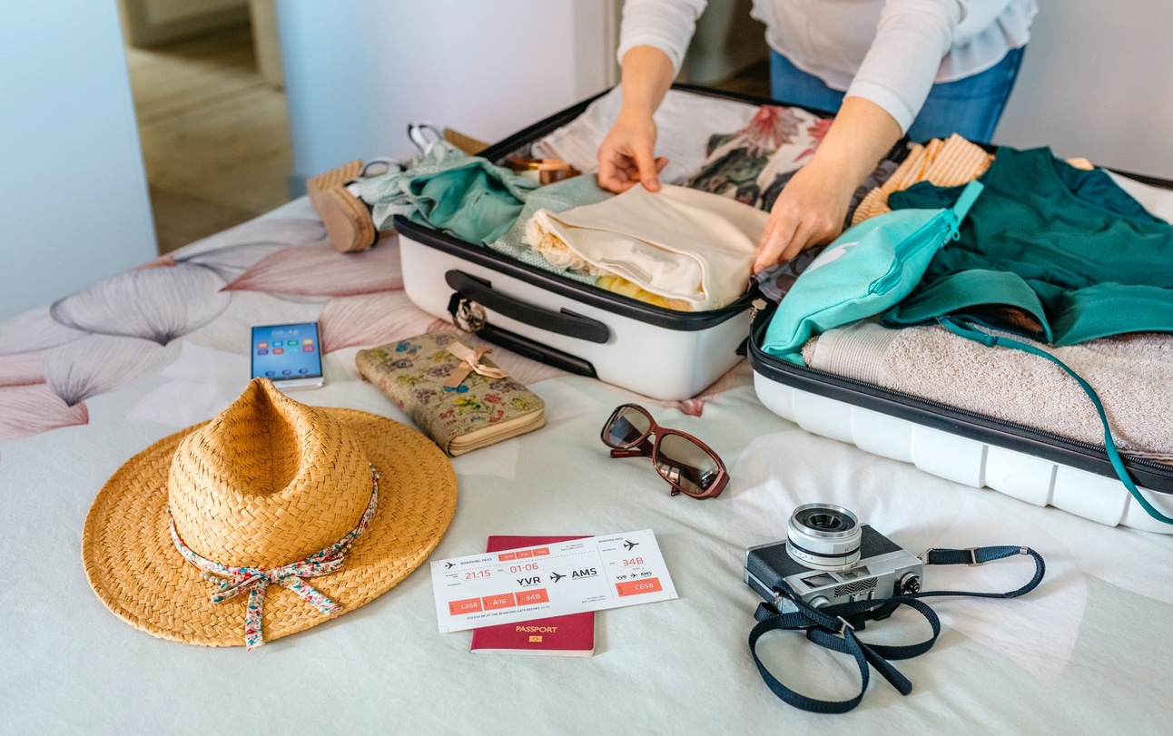 Beach packing, suitcase on bed