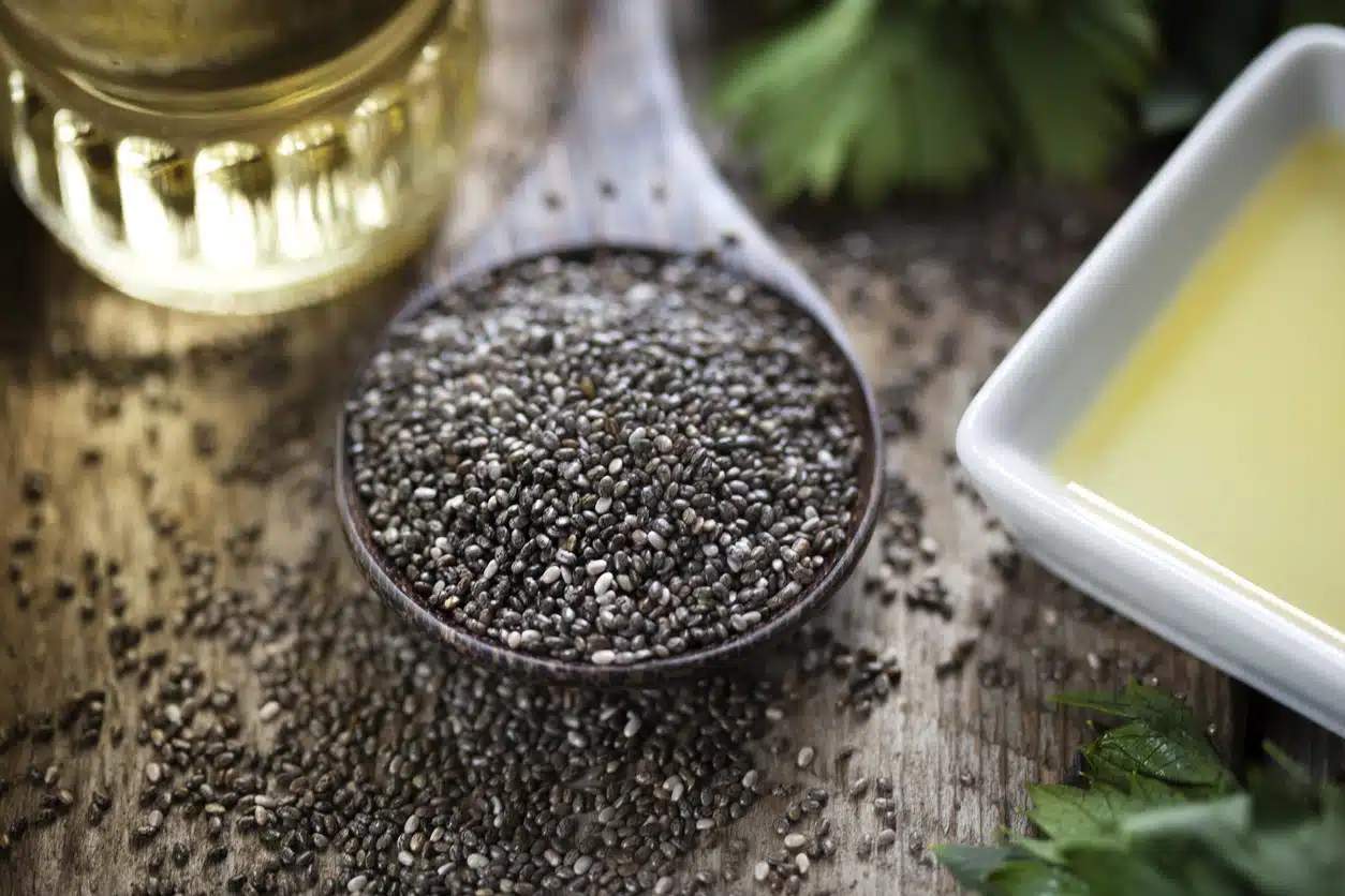 Wooden spoon with chia seeds (salvia hispanica) and chia oil