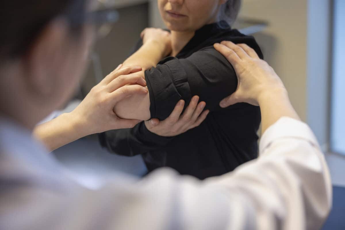 Doctor examining a woman's shoulder