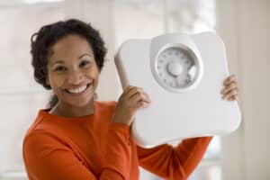 Top 5 diets of 2023, woman holding a scale