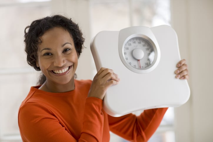 Top 5 diets of 2023, woman holding a scale