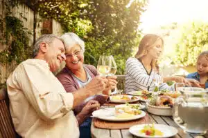 Shot of a family eating lunch together outdoors