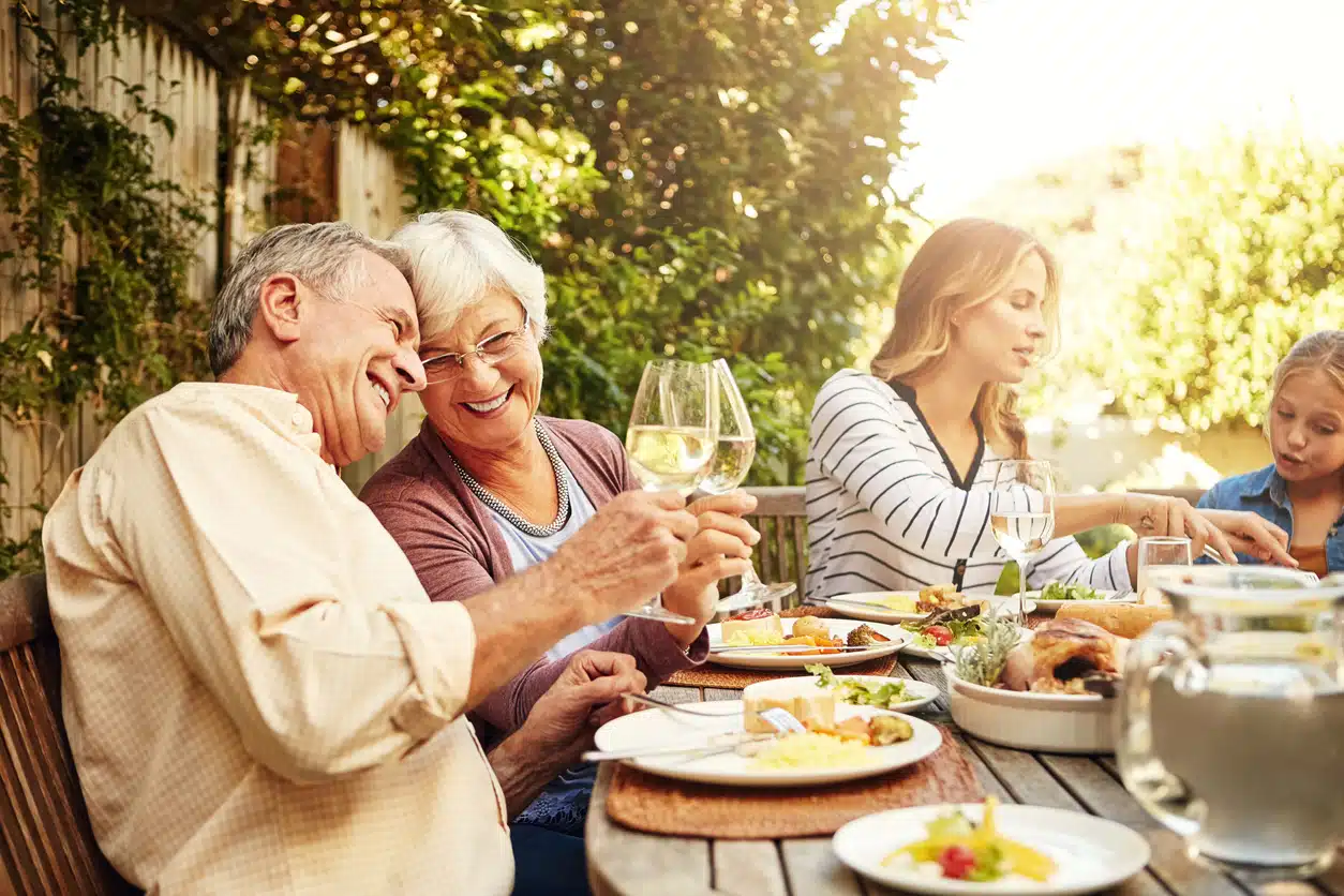 Shot of a family eating lunch together outdoors