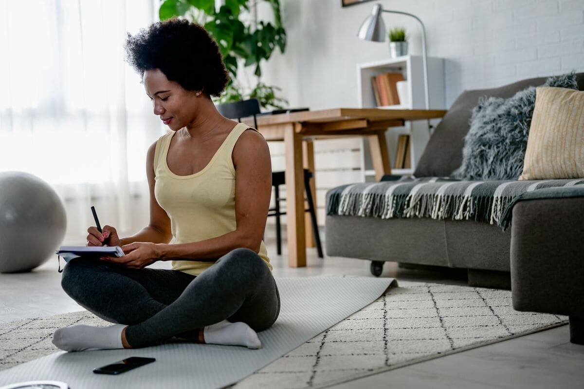 woman journaling on the floor