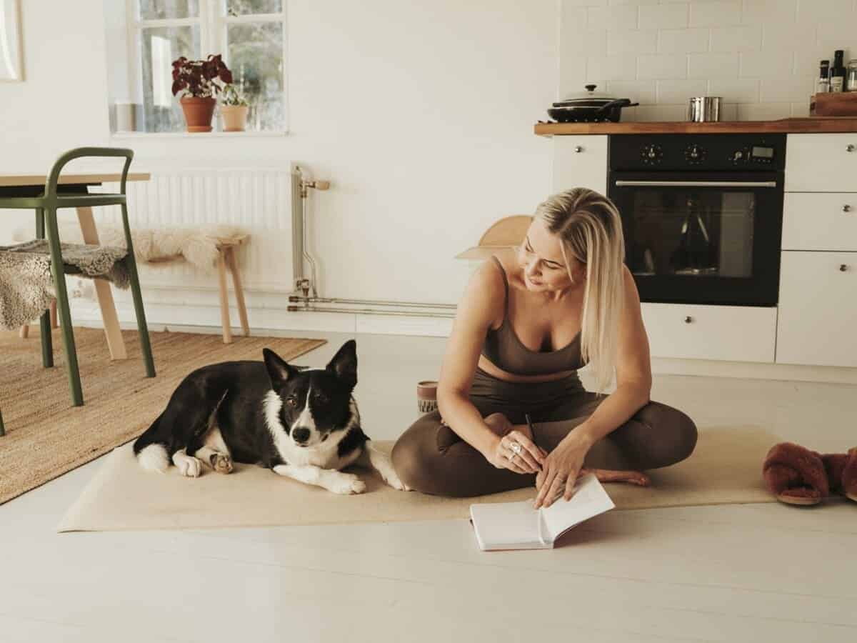 woman journaling with her dog
