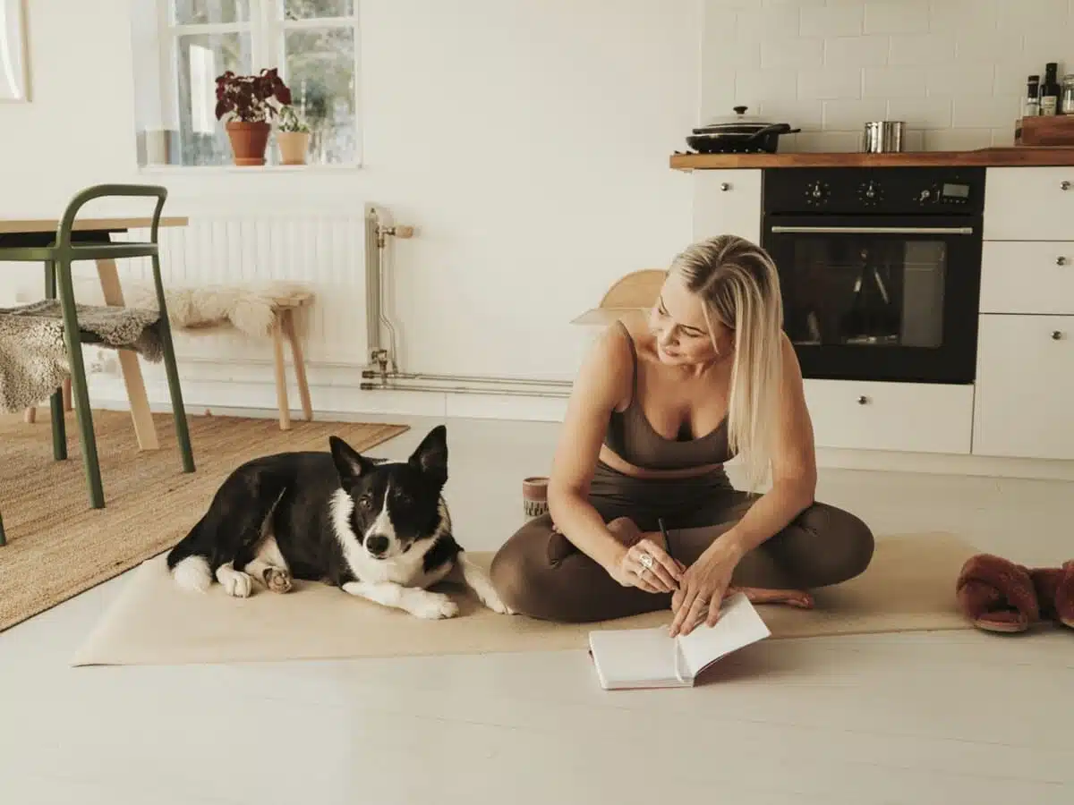 woman journaling with her dog