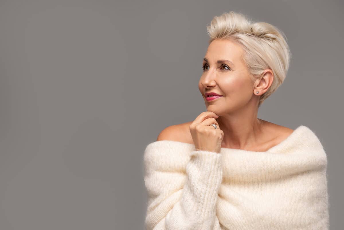 Stylish woman with short hair and bared shoulders
