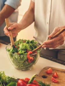 Senior couple cooking together at home meal preparation