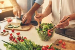 Senior couple cooking together at home meal preparation