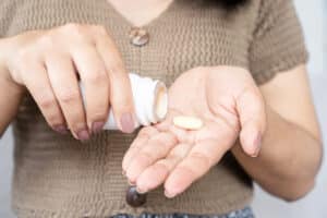 Woman taking supplements.