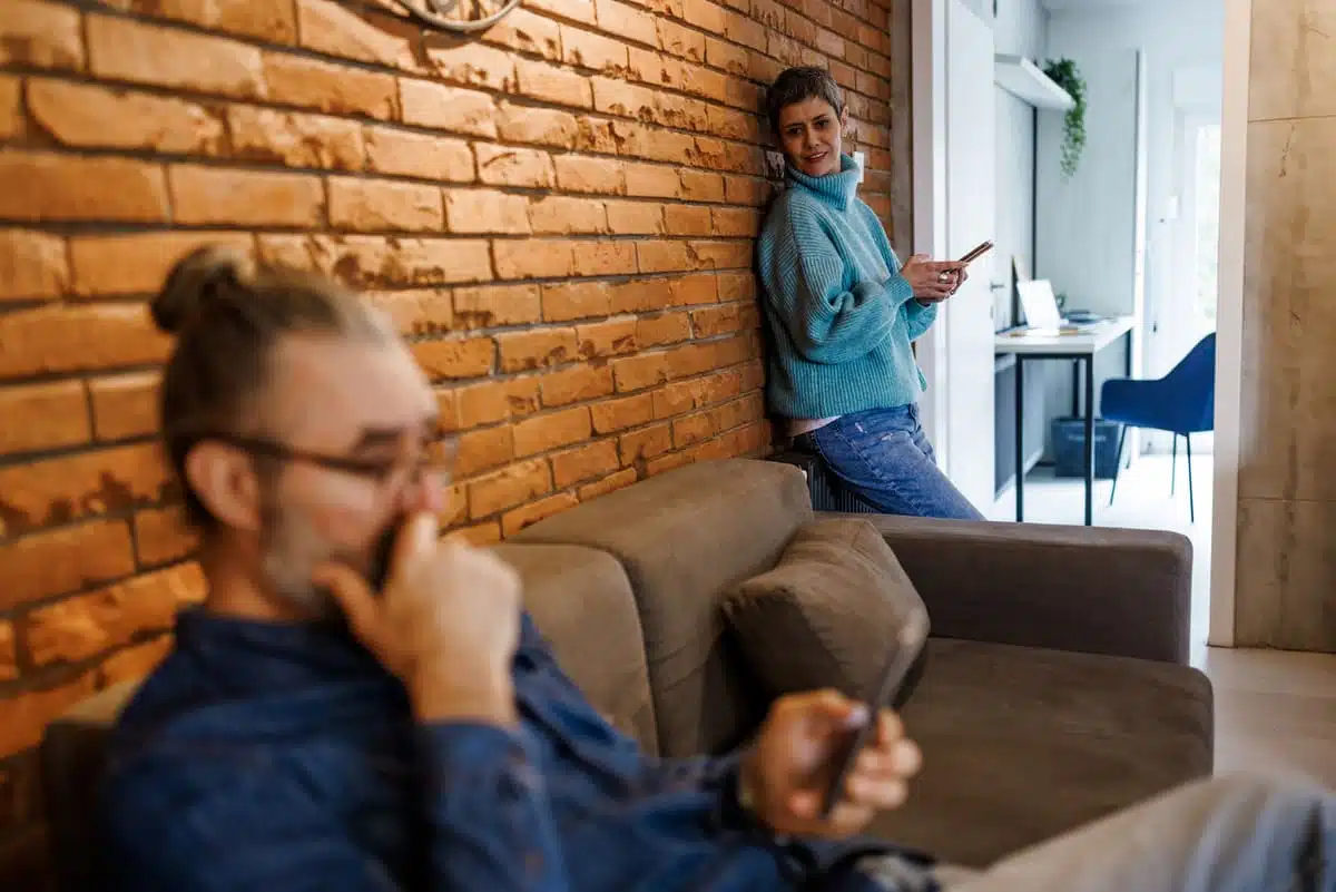 man on phone ignoring woman