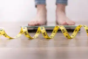 Lumen metabolic weight management; weight loss, woman on a scale