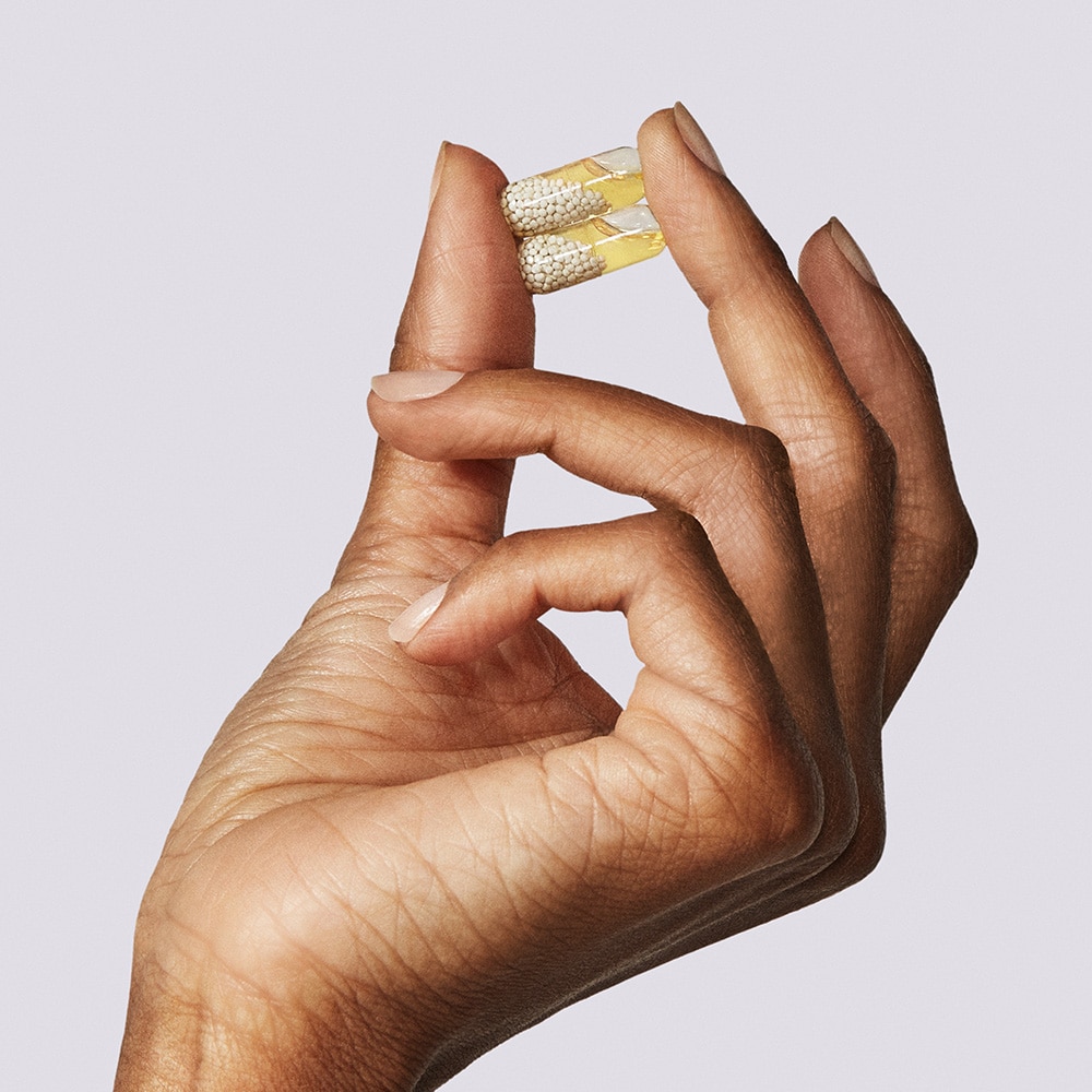 Ritual Essential for Women 50+ hand holding pills