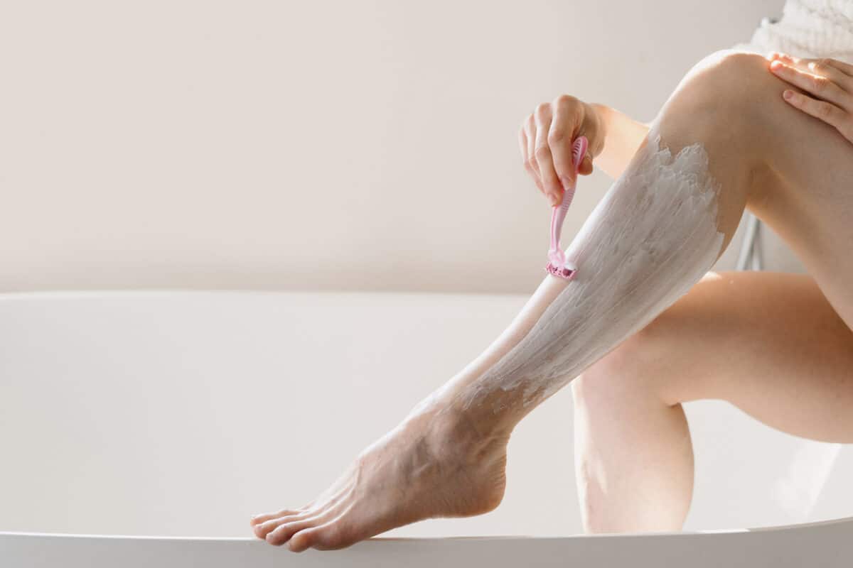 Woman shaving her legs