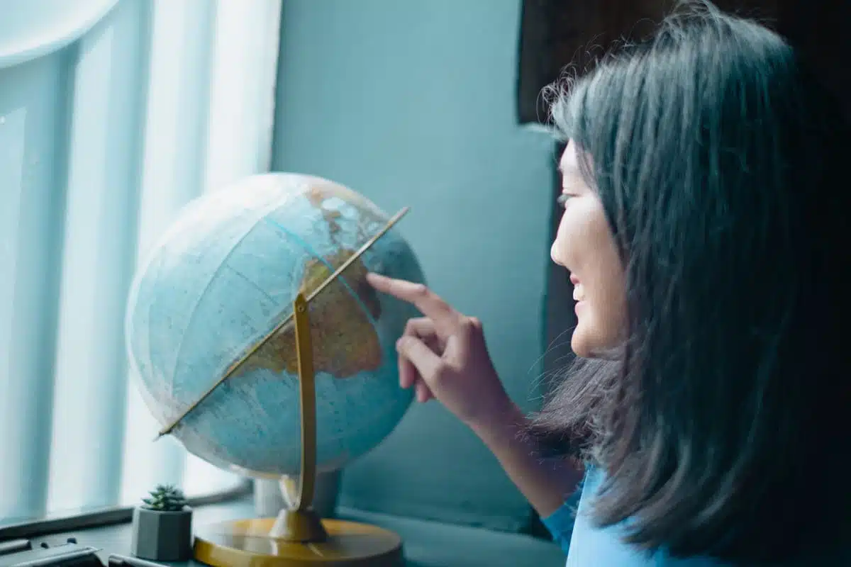 Woman looking at a globe
