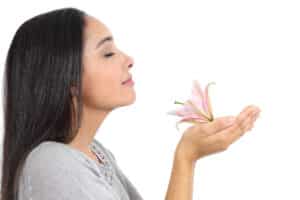 Scent and memory; woman smelling a flower