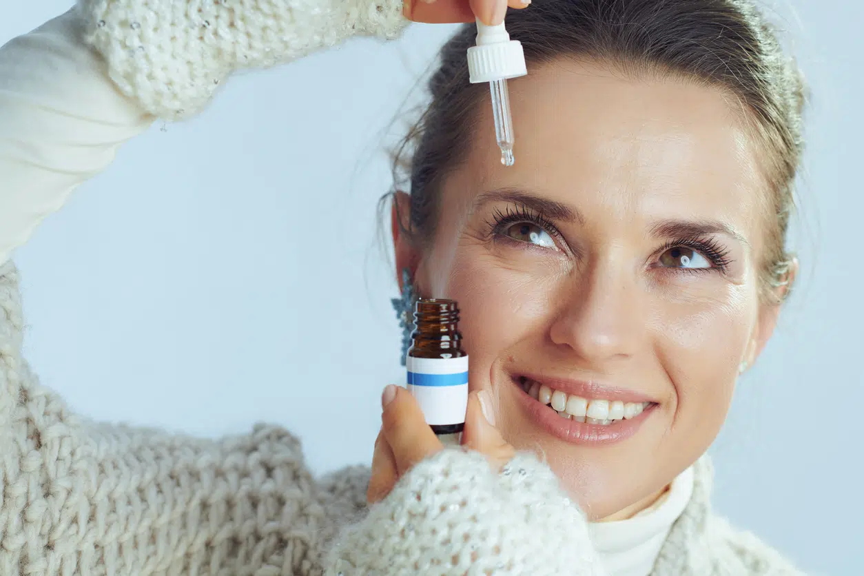 Eyebrow serums; woman applying serum to her face or brows